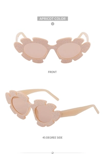 Detail view of wavy glitter flower sunglasses in apricot with front and side profile