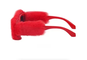 Detailed 90-degree side view of red faux fur sunglasses showing soft plush texture