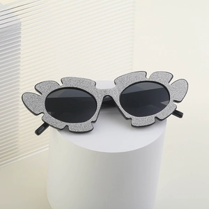 Irregular glitter flower sunglasses for women with gray frames and round black lenses
