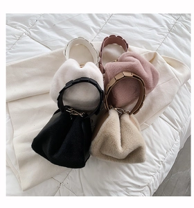 Detail of plush bucket bags with knotted handles in white, pink, black and khaki colors