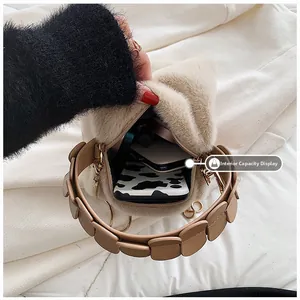 Interior view of beige faux fur handbag showing spacious capacity for essentials