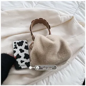 Detailed comparison of compact fuzzy faux fur handbag size against a smartphone