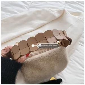 Macro detail of sturdy faux fur handbag with unique layered leather handle and gold zipper