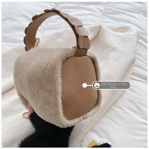 Detail view of the fuzzy faux fur texture and unique petal-shaped handle on a beige tote bag