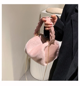 Detail of pink faux fur handbag featuring unique scalloped petal design shoulder strap