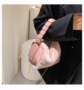 Detail of pink faux fur handbag showing long-pile texture and tiered leather handle