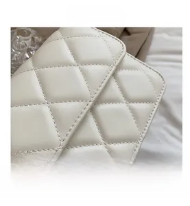 Macro shot of beige quilted faux leather flap with classic diamond stitch texture