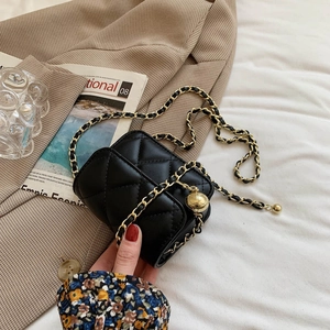 Quilted black crossbody bag with gold adjustable chain strap on checkered blazer background