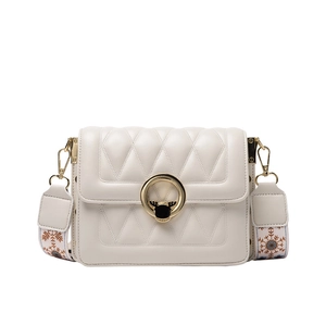 Off-white quilted crossbody square bag with gold reindeer clasp and wide snowflake strap