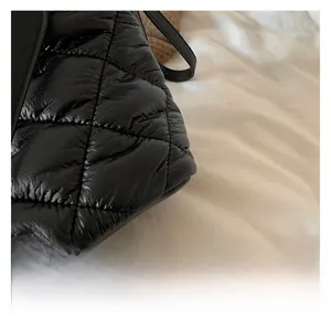Close-up of black quilted diamond pattern fabric with premium stitching on a bucket bag