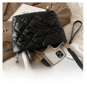 Interior view showing the large capacity of the black quilted puffer bucket bag