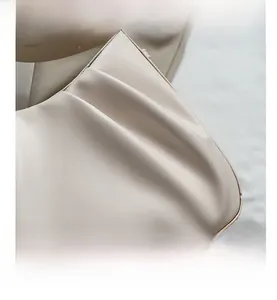 Close-up of cream pleated texture and soft faux leather material of the bucket bag