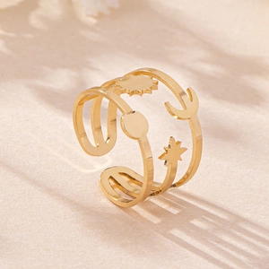 Detail of gold moon sun and star open ring featuring a triple-layer stacked line design