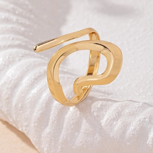 Minimalist gold open ring with irregular organic fluid design on textured stone base