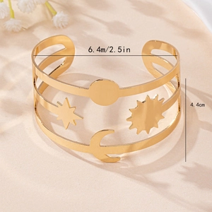 Luxury gold hollow cuff bracelet with celestial star and moon motifs in a polished finish