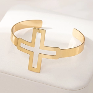Polished gold hollow cross open cuff bracelet for women in a minimalist religious style