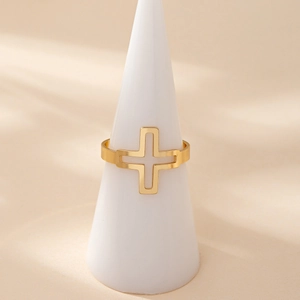 Minimalist gold-plated stainless steel ring with a hollow cross design on a white stand