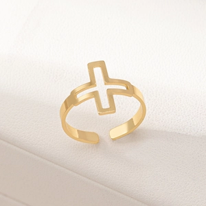 Detailed close-up of a gold hollow cross ring featuring an adjustable open band design