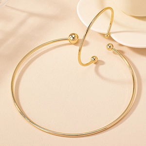 Minimalist gold geometric choker and open cuff bracelet set with polished metal spheres
