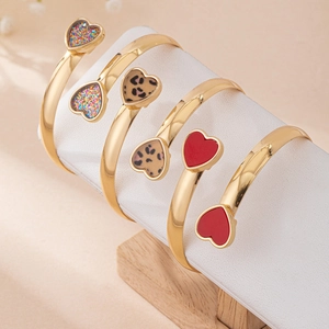 Three-piece gold open heart bracelets featuring leopard print, red glaze, and glitter