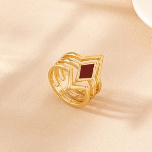 Vintage gold hollow geometric ring with red enamel diamond detail at 45-degree angle
