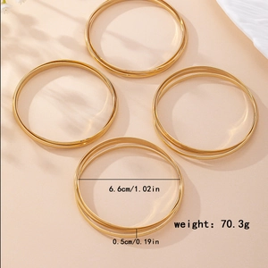 Set of 4 minimalist gold-plated geometric bangles with thin wire stackable design