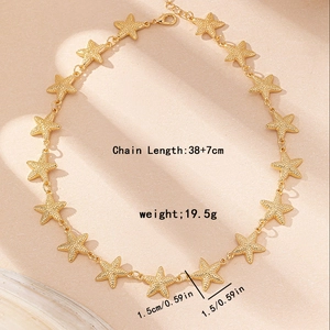 Golden starfish pendant necklace with 38+7cm chain and textured nautical charms