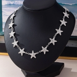 Chic silver star pendant necklace with cubic zirconia pave stones on black neck model