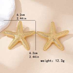 Exaggerated large gold starfish stud earrings with textured finish measuring 6.2cm
