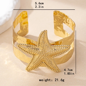 Golden starfish cuff bracelet with hammered metal texture and beach vacation style