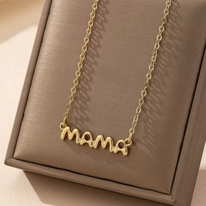 Minimalist golden mama pendant necklace displayed on a luxury leather jewelry case