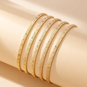 Bohemian gold engraved bangle set with 5 pieces featuring vintage geometric patterns