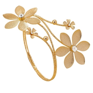 Elegant gold flower arm cuff featuring frosted metal blooms and sparkling crystals