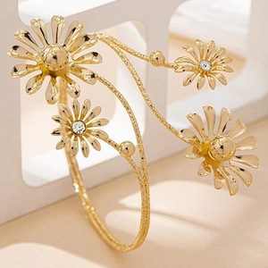 Golden daisy flower wrap arm cuff with crystal accents and adjustable open design