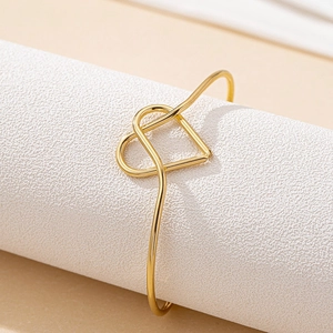 Bracelet jonc doré élégant en forme de cœur entrelacé avec finition polie