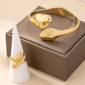 Minimalist gold snake-style jewelry set with adjustable open bangle and matching ring
