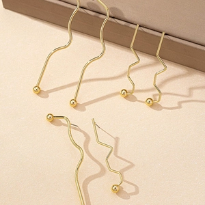 Minimalist geometric gold metal earrings with wavy and zigzag line designs for women