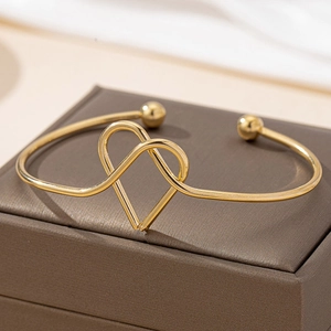 Bracelet jonc ouvert doré en forme de cœur avec embouts sphériques sur écrin