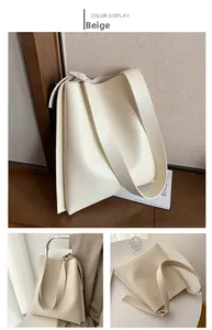 Detail view of large beige PU leather tote bag with wide shoulder strap and spacious interior