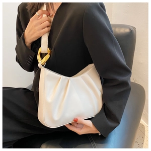 Chic beige pleated cloud bucket bag featuring bold gold ring hardware detail and hobo style