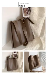 Detailed side view of khaki PU leather tote bag with wide strap and gusset structure
