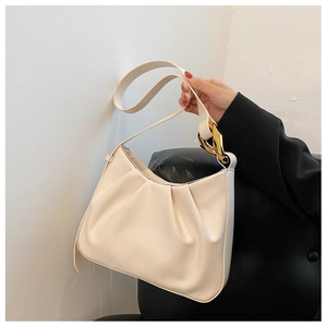Detail of off-white ruched hobo bag featuring elegant pleats and golden metal chain link