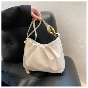 Detail view of white ruched cloud bag with stylish chunky gold metal chain strap
