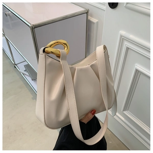 Detail view of off-white ruched handbag featuring a bold oval gold metallic chain link
