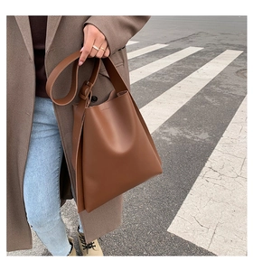Deep coffee large capacity tote bag shown in professional outdoor street style view