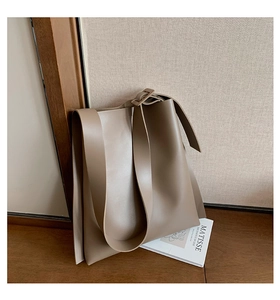 Detail of camel faux leather tote bag showing smooth matte finish and adjustable strap