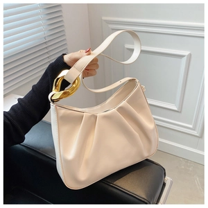 Close-up of beige ruched cloud bag with distinctive chunky gold metal chain hardware