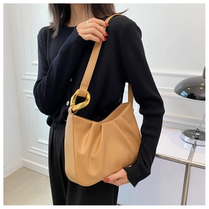 Detail of ruched texture and golden buckle on khaki cloud bucket shoulder bag