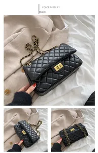 Close-up of black quilted shoulder bag featuring golden clasp and chain strap detail