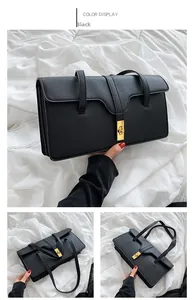 Detailed view of black underarm bag with lychee texture and golden metal twist lock